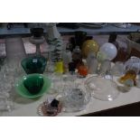 A glass oil lamp, a selection of glass lamp shades, together with a green glass fruit set, bowls,