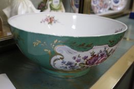 A Continental china bowl, green ground with floral decoration and gilt highlights, 29cm in