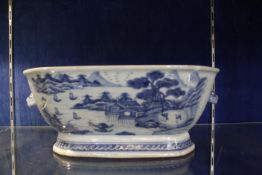 A Chinese blue and white tureen base, with animal mask handles, landscape decoration, 34cm approx.