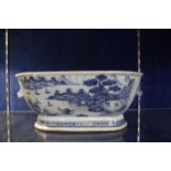 A Chinese blue and white tureen base, with animal mask handles, landscape decoration, 34cm approx.