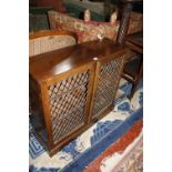 A 19th century mahogany cabinet with brass grill doors. 92cm wide.