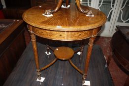 An Edwardian side table with a segmented top with flower petal inlay on reeded supports.76cm diam.