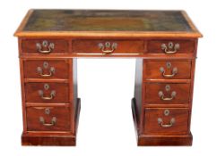 A mahogany twin pedestal desk, first half 19th century, the green leather inset top above three