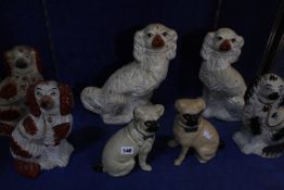 A group of assorted Staffordshire spaniels, together with a near pair of seated pug dogs -14 (some