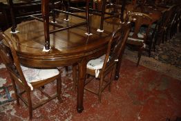 A Chinese hardwood dining table 169cm length and a set of six hardwood dining chairs to include