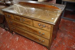 An Edwardian mahogany satinwood banded chest of drawers with glass protective cover.120cm wide x