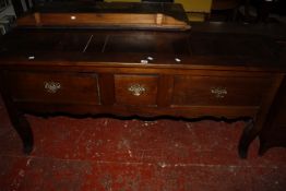 An 18th Century style low dresser with three drawers on shaped legs 176cm wide
