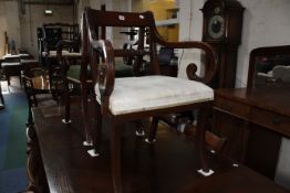 Eight Regency style dining chairs bar backs with rope twist detail raised on sabre supports.