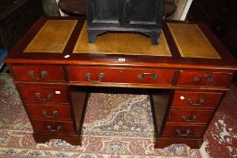 A Georgian style mahogany finish pedestal desk, leather line three segmented top.122cm x 61cm