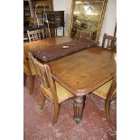 A Victoria mahogany wind out extending dining table with two extra leaves raised on turned