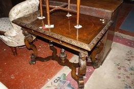 A carved oak and walnut inlaid centre table in the Jacobean style with a single frieze drawer and