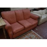 A three seat sofa in coral pink upholstery.180cm wide Best Bid