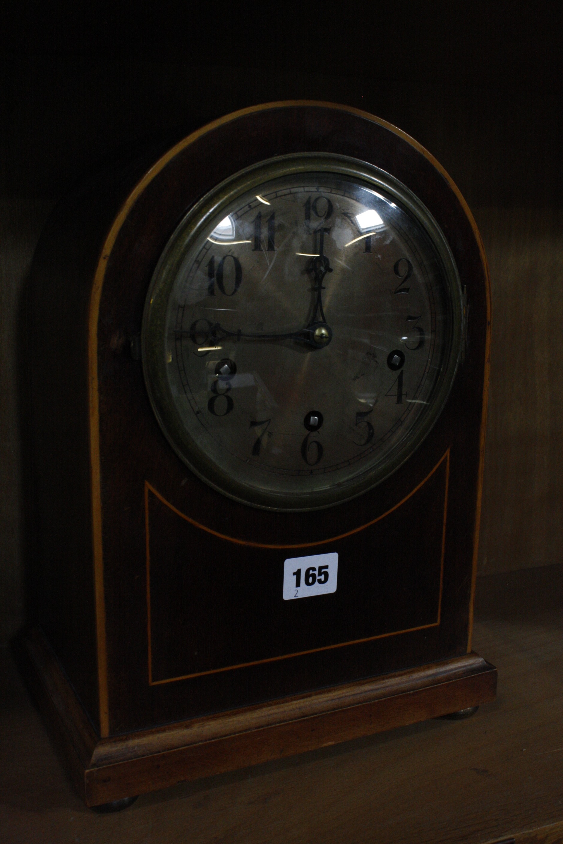 An Edwardian mahogany mantel clock by Sanders, Peckham, 34cm high, an oak barometer and another