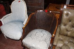 An early 20th century Georgian style cane back tub chair on cabriole supports and a French style