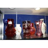 A quantity of decorative ceramics and glassware to include a cranberry glass jug, other coloured