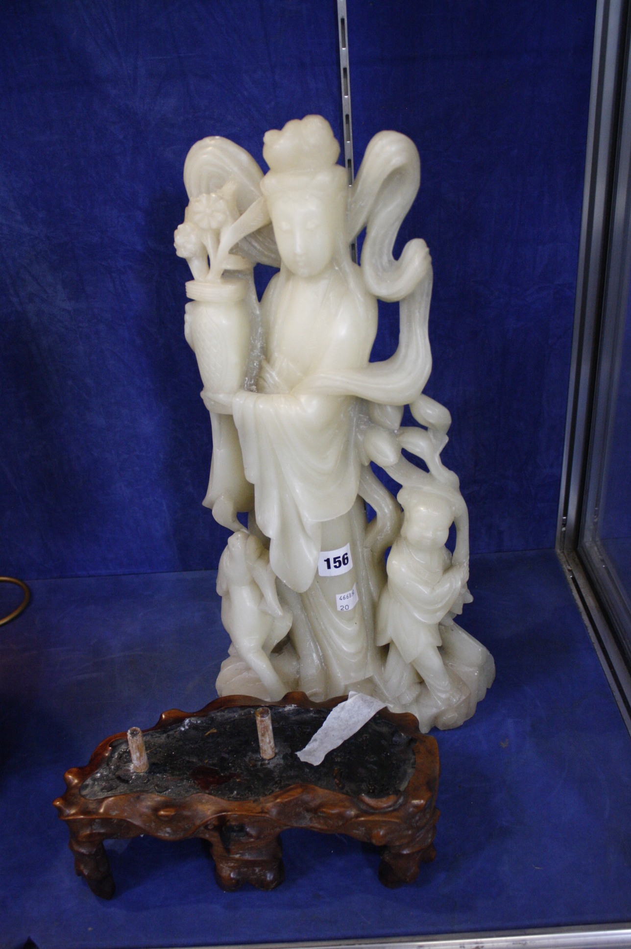 A large carved steatite (soapstone) figure of Guanyin, goddess of mercy, 50cm high with a shaped