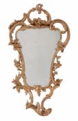 A George III carved giltwood wall mirror,   circa 1760, in the manner of Thomas Johnson, the shaped