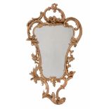 A George III carved giltwood wall mirror,   circa 1760, in the manner of Thomas Johnson, the shaped