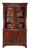 -108  A Regency mahogany and glazed cabinet bookcase  , circa 1815, the dentil cornice above an