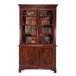 -108  A Regency mahogany and glazed cabinet bookcase  , circa 1815, the dentil cornice above an