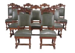 A set of eighteen carved walnut dining chairs, circa 1890, each padded rectangular back with C