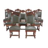 A set of eighteen carved walnut dining chairs, circa 1890, each padded rectangular back with C