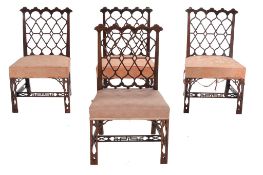 A set of four George III mahogany chairs, circa 1800, after a design by Thomas Chippendale, each