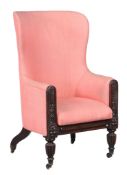 A Regency mahogany and upholstered wing armchair,   circa 1815, with a curved back and padded seat,