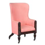 A Regency mahogany and upholstered wing armchair,   circa 1815, with a curved back and padded seat,