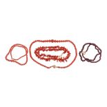 A coral bead necklace, composed of graduating circular shaped coral beads, to a reeded circular