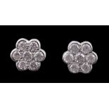 A pair of diamond set cluster ear studs, designed as a flower head, set with brilliant cut
