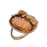 A citrine dress ring, the flattened oval shaped citrine with a recumbent tiger surmount, with