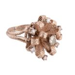 A diamond cluster ring, the textured ribbon bow design set with brilliant cut diamonds,