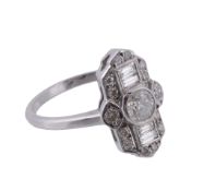 A diamond ring, the central brilliant cut diamond collet set within a surround of baguette cut and