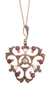 A pink sapphire and half pearl necklace, the openwork foliate panel set with circular shaped pink