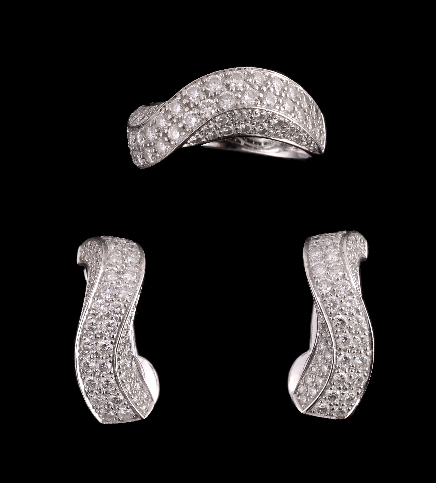 A pair of diamond earrings and a ring, the earrings of twisted design set with brilliant cut