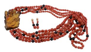 A coral and amber necklace, the four graduated strands of coral with facetted black beads, to an