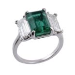 An emerald and diamond ring, the rectangular shaped emerald, estimated to weigh 3.70 carats in a