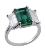 An emerald and diamond ring, the rectangular shaped emerald, estimated to weigh 3.70 carats in a