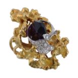 An amethyst and diamond dress ring, the crystal shaped amethyst encircled by a brilliant cut