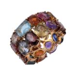 A multi gem set ring, the band set throughout with vari cut gemstones, including, sapphire, yellow