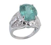 A paraiba tourmaline and diamond ring, the central oval shaped paraiba tourmaline in a raised four