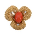A coral and diamond flower head brooch , the three lobed wirework flower head centred with an oval