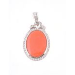 A coral and diamond pendant, the oval cabochon panel within a brilliant cut diamond surround and