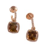 A pair of sphene and diamond earrings, the square shaped sphene claw set within a surround of