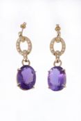 A pair of amethyst and diamond earrings , the oval shaped amethyst in a four claw setting, to a