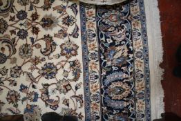 A Persian carpet with cream ground and floral motif 352 x 248cm £400-600