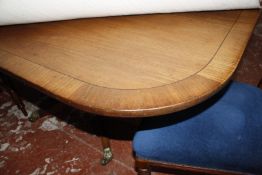 A Regency mahogany crossbanded breakfast table on a turned column base with four swept supports.
