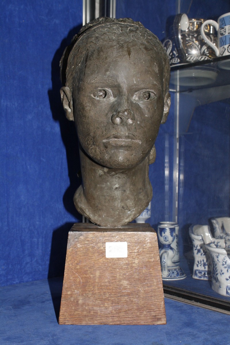 British school (mid 20th century), a plaster bust of a young lady, unsigned, on a wooden plinth,