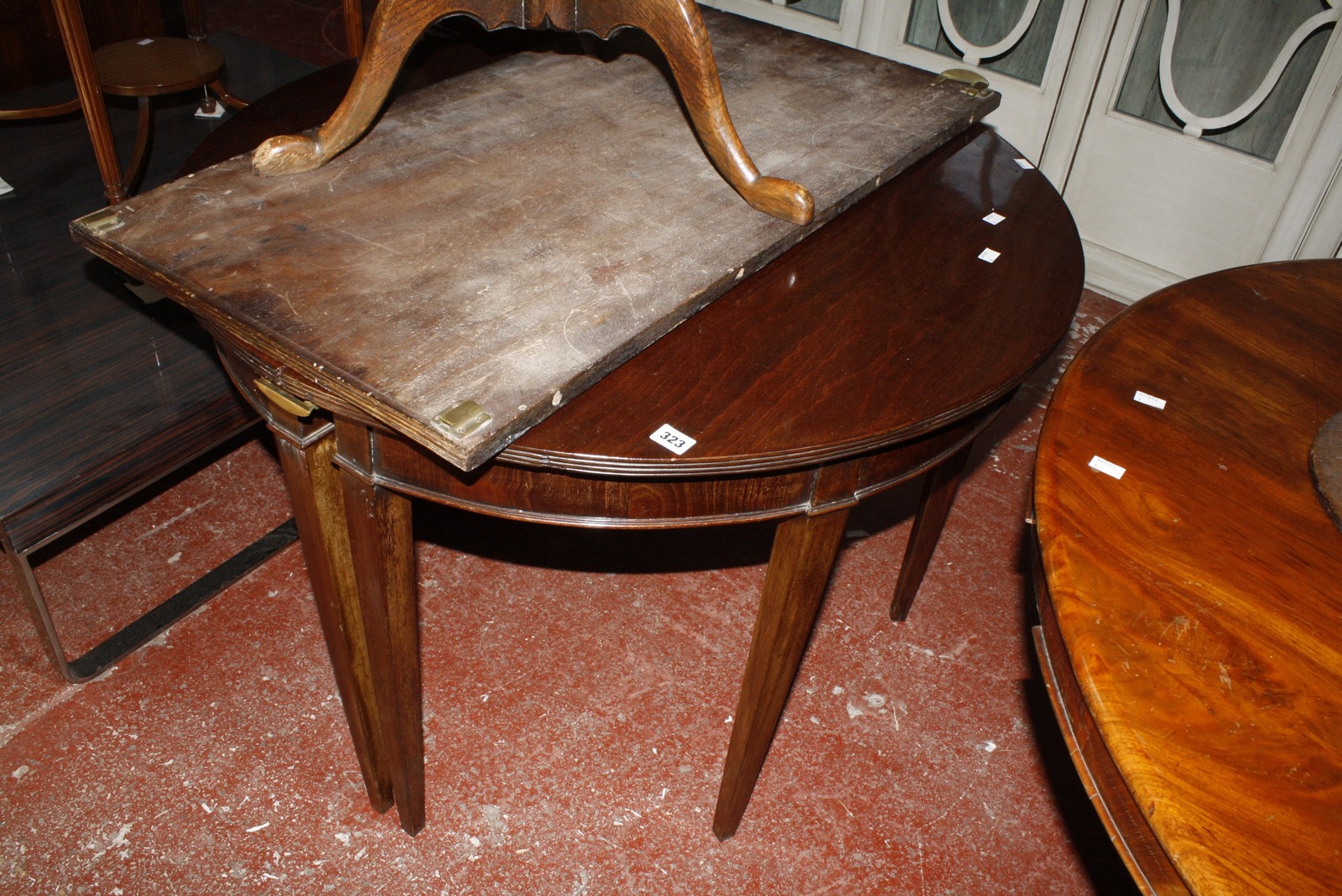 A Georgian mahogany D-end dining table, with a single centre leaf on square tapered supports. £100-